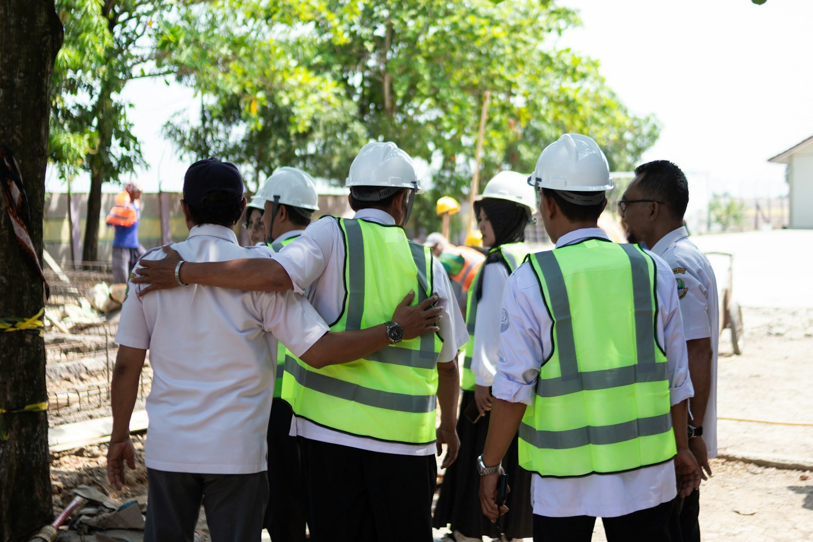 Construction workers in hard hats and safety vests on site